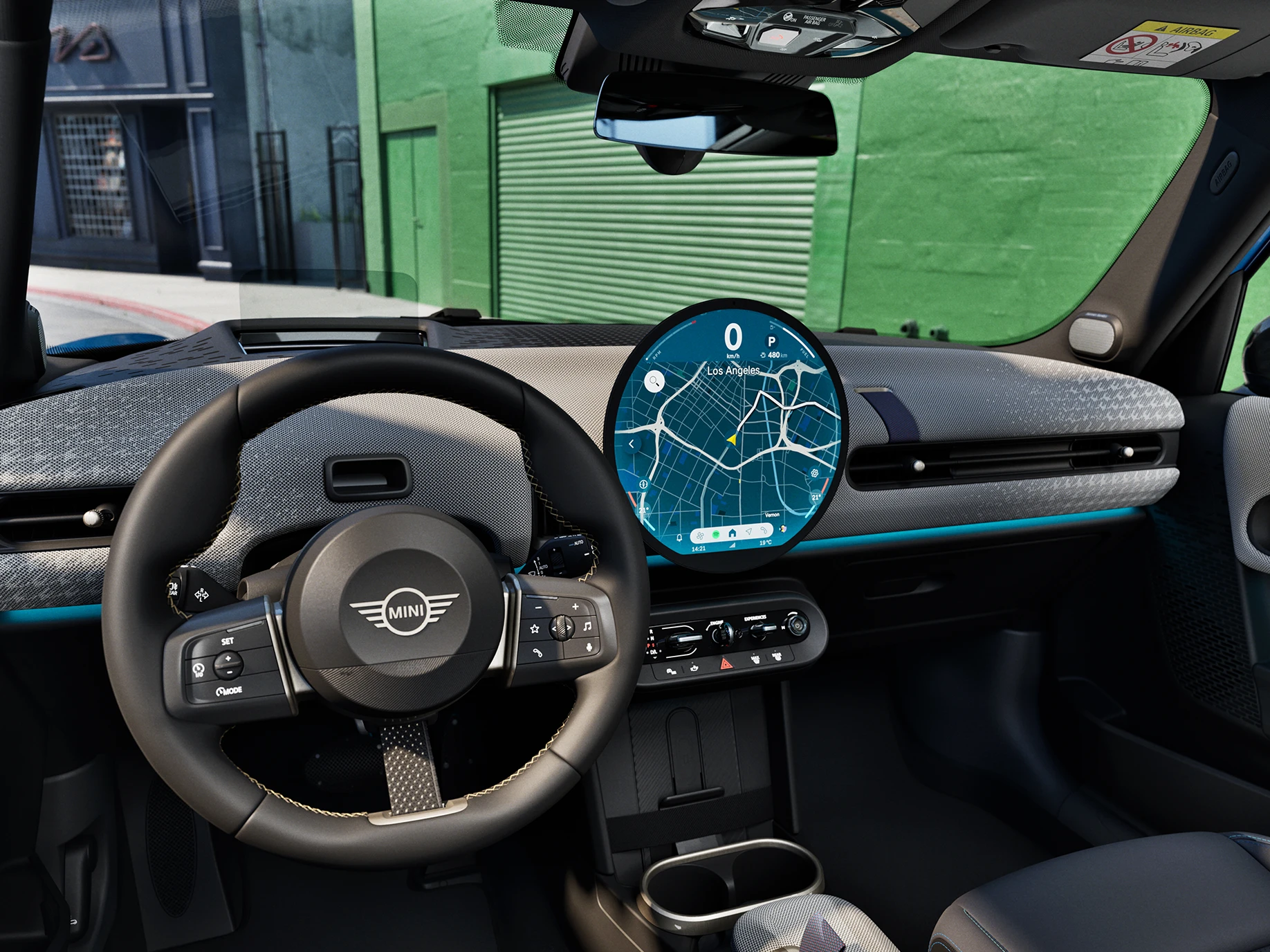 Interior view of the MINI Cooper 5-Door with focus on the steering wheel, the dashboard and the interaction unit.