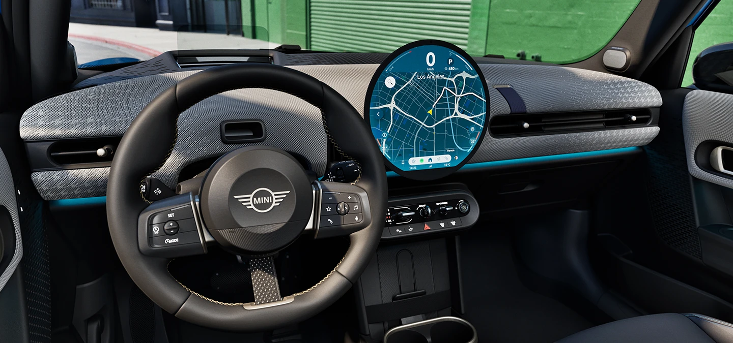 Interior view of the MINI Cooper 5-Door with focus on the steering wheel, the dashboard and the interaction unit.