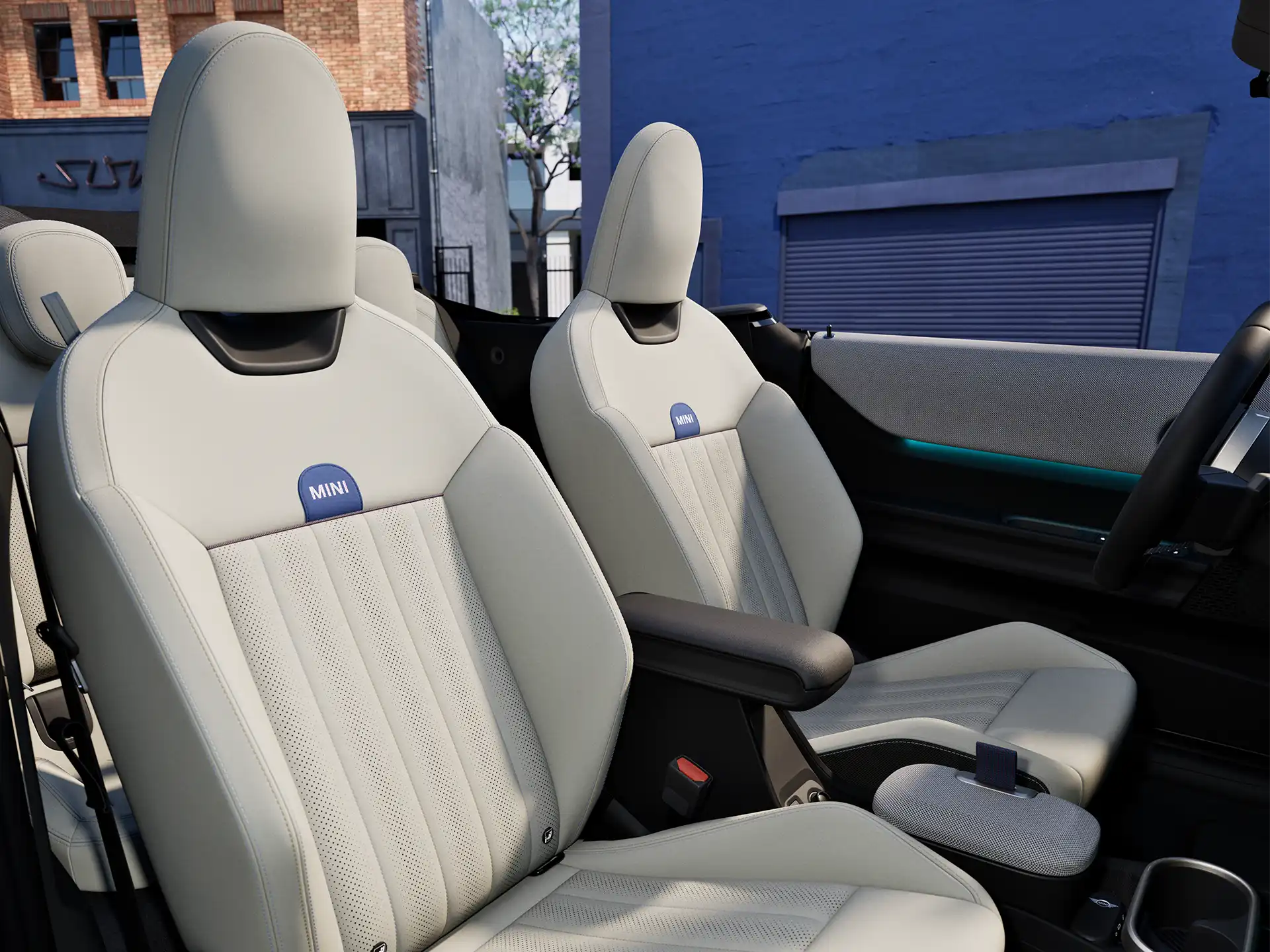 Interior perspective of the MINI Cooper Convertible  is showing the dashboard, steering wheel, round display and back of the frontseats.